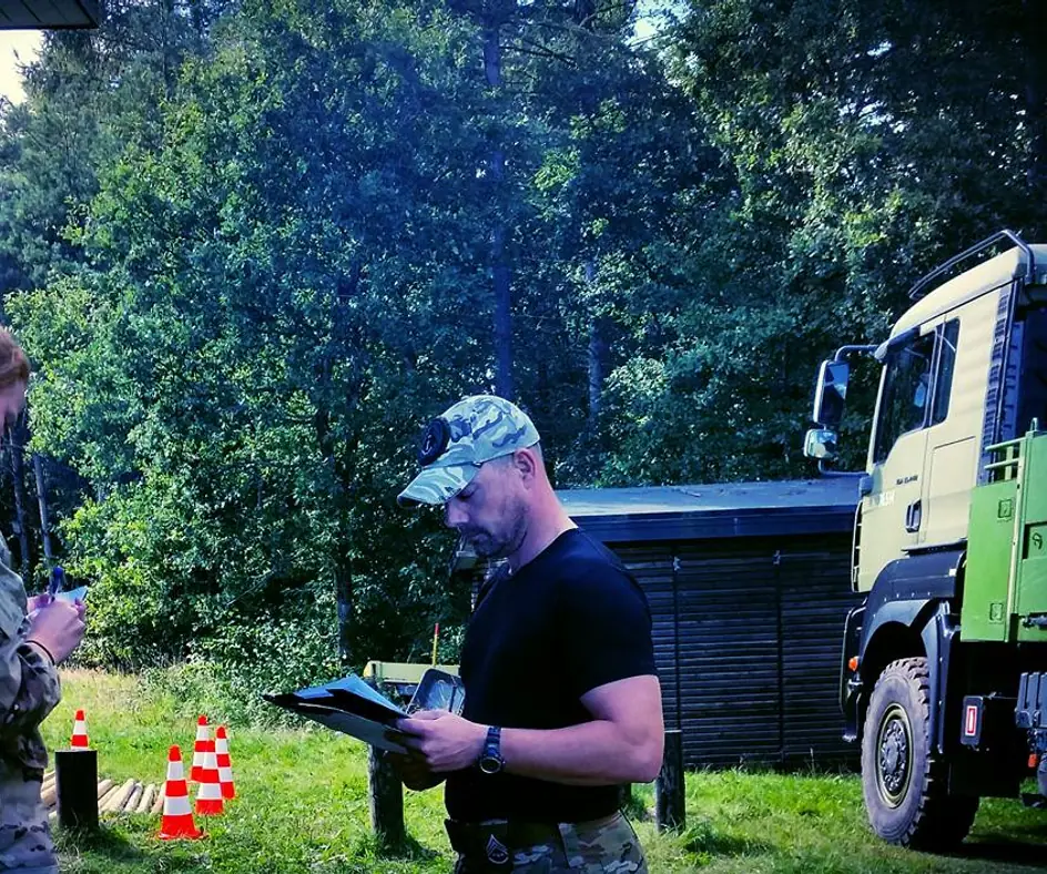 Thomas Larsen with a clipboard, instructing in the field for the Royal Danish Air Force